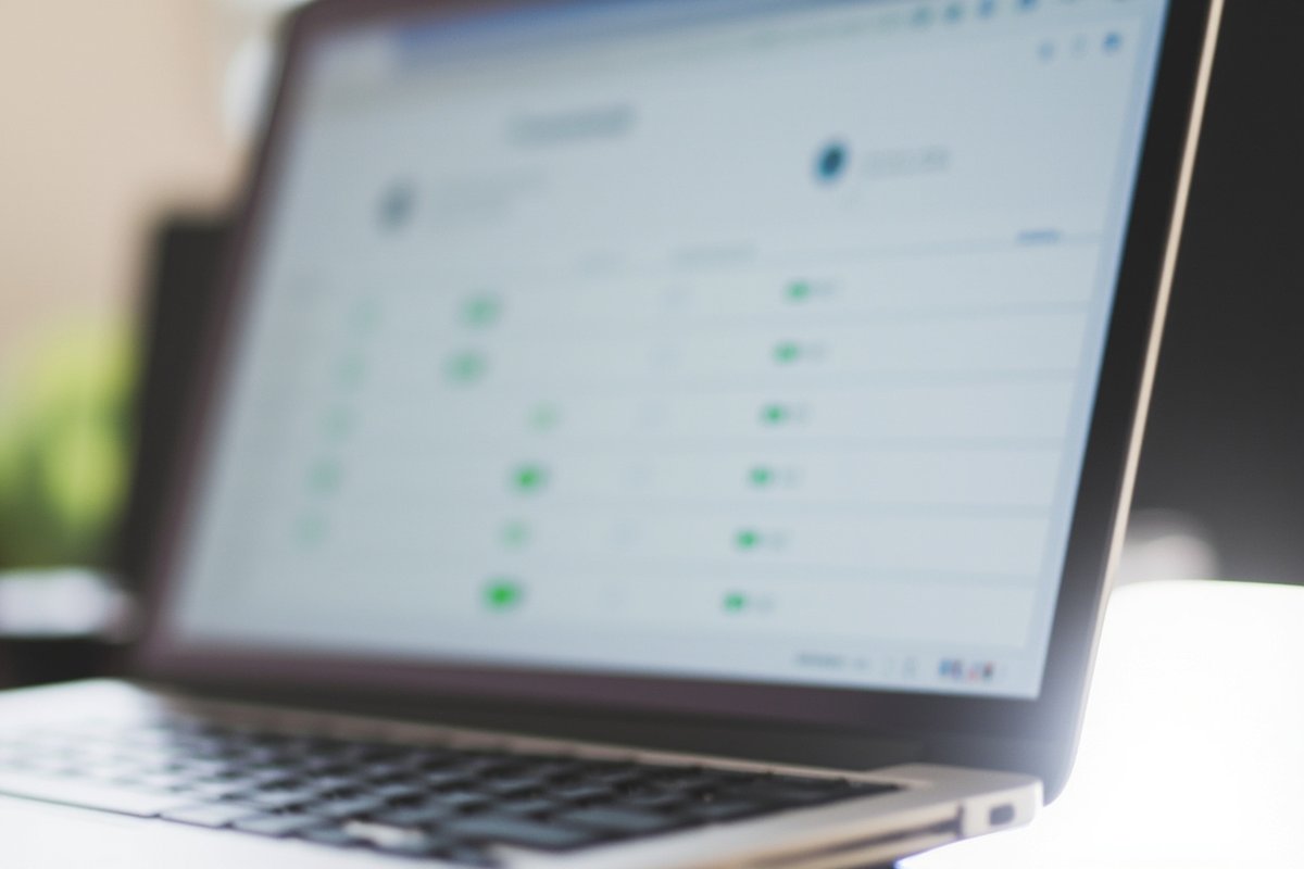 A laptop screen showing the ESMA Crypto-Asset Service Provider public register page, with a list of authorised EU firms and a green status badge beside each entry